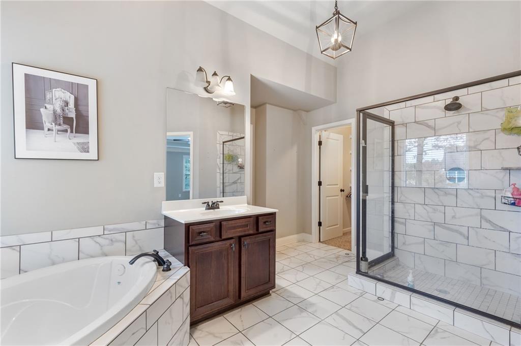 1023 Ruddy Duck Drive Jefferson, GA 30549 - Photo 40 of 69 a bathroom with a tub sink shower and mirror