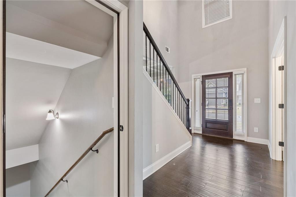 1023 Ruddy Duck Drive Jefferson, GA 30549 - Photo 46 of 69 a view of a hallway with wooden floor staircase and a white doors