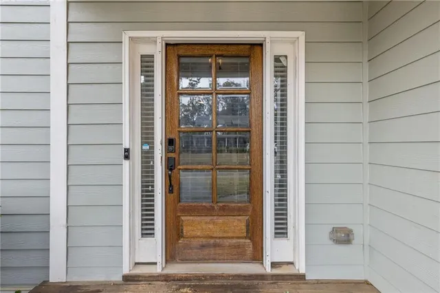 a view of a room with wooden floor and windows