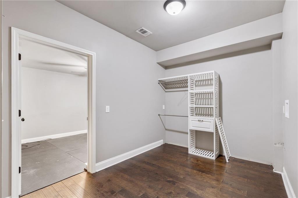 1023 Ruddy Duck Drive Jefferson, GA 30549 - Photo 53 of 69 an empty room with wooden floor cabinet and windows