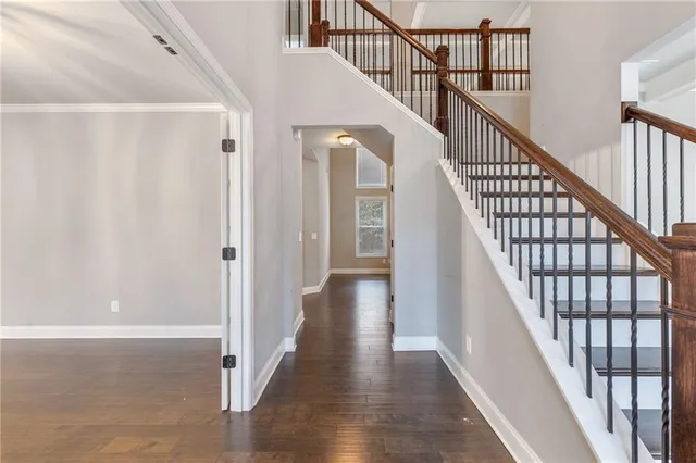 a view of an empty room with wooden floor