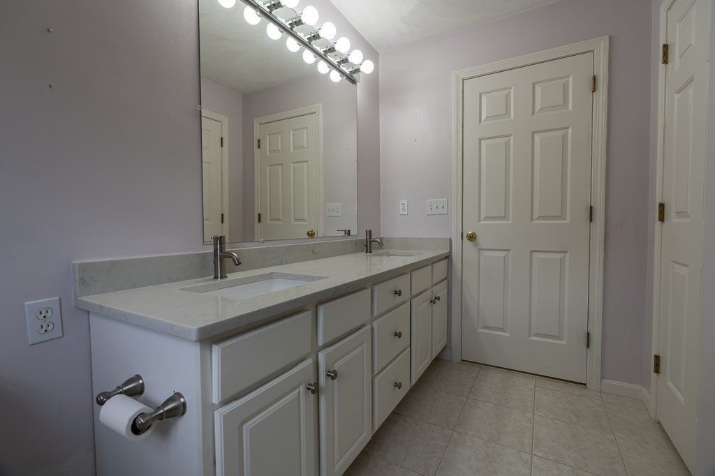 31 Hickory Lane Hudson, MA 01749 - Photo 20 of 40 a bathroom with a sink and mirror