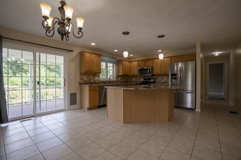 31 Hickory Lane Hudson, MA 01749 - Photo 8 of 40 a kitchen with stainless steel appliances granite countertop a refrigerator a sink dishwasher a oven with white cabinets