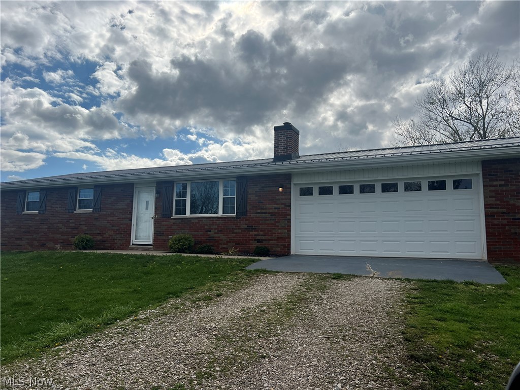 1365 Greenlees Road Fleming, OH 45729 - Photo 1 of 3 Single story home featuring a front yard and a garage