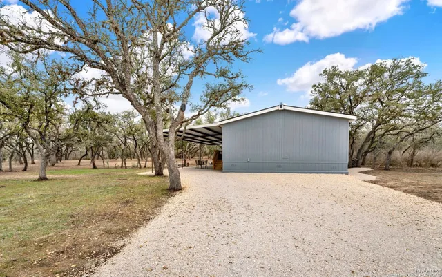 a front view of house with yard and trees