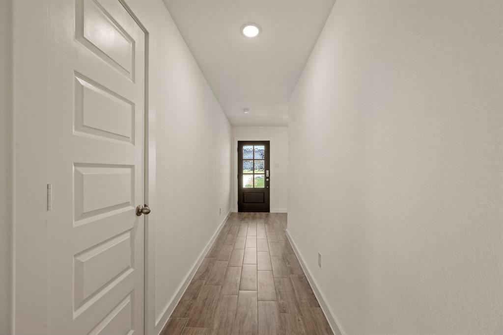 1016 Gatlin Circle Springtown, TX 76082 - Photo 5 of 30 a view of a hallway with wooden floor