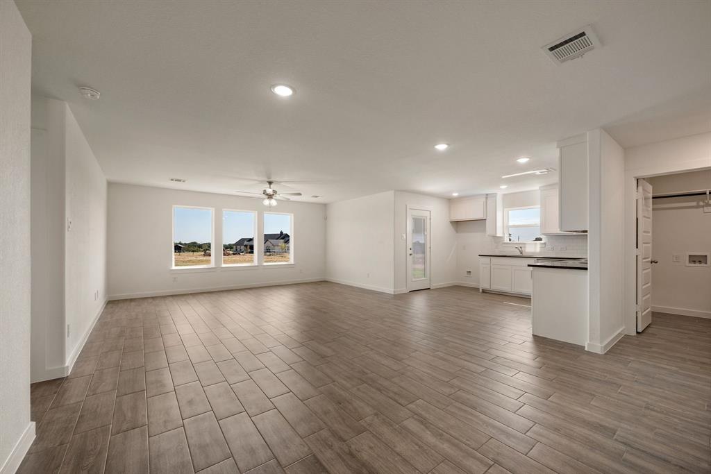 1016 Gatlin Circle Springtown, TX 76082 - Photo 7 of 30 a view of a kitchen with cabinets and wooden floor
