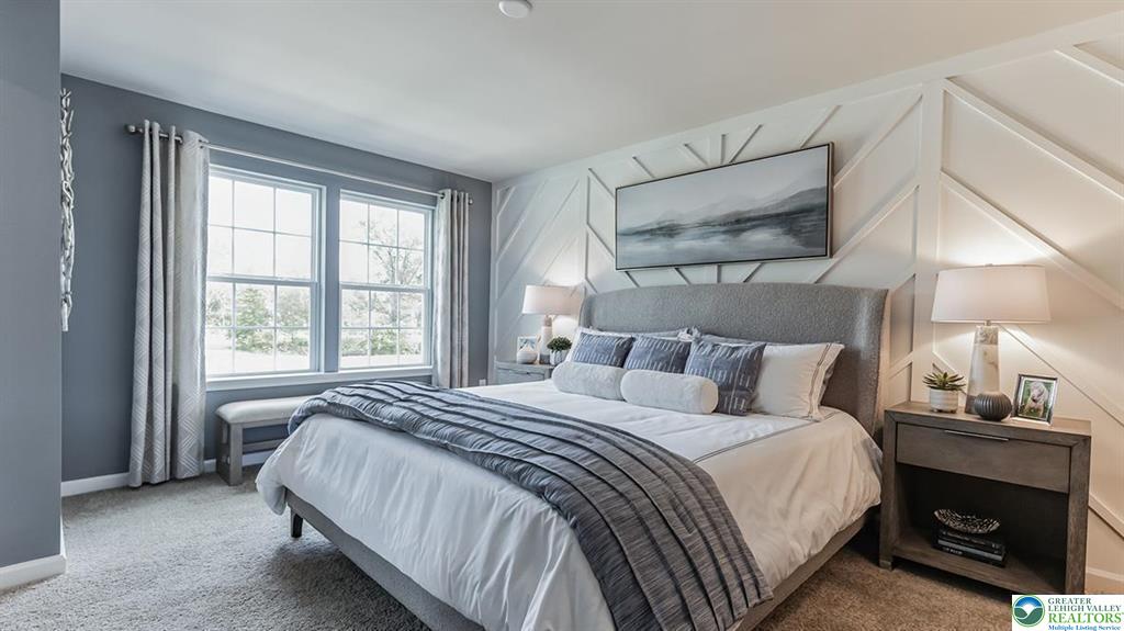 1145 Martin Road Breinigsville, PA 18031 - Photo 14 of 38 A tranquil primary bedroom suite featuring a striking accent wall and ample natural illumination.