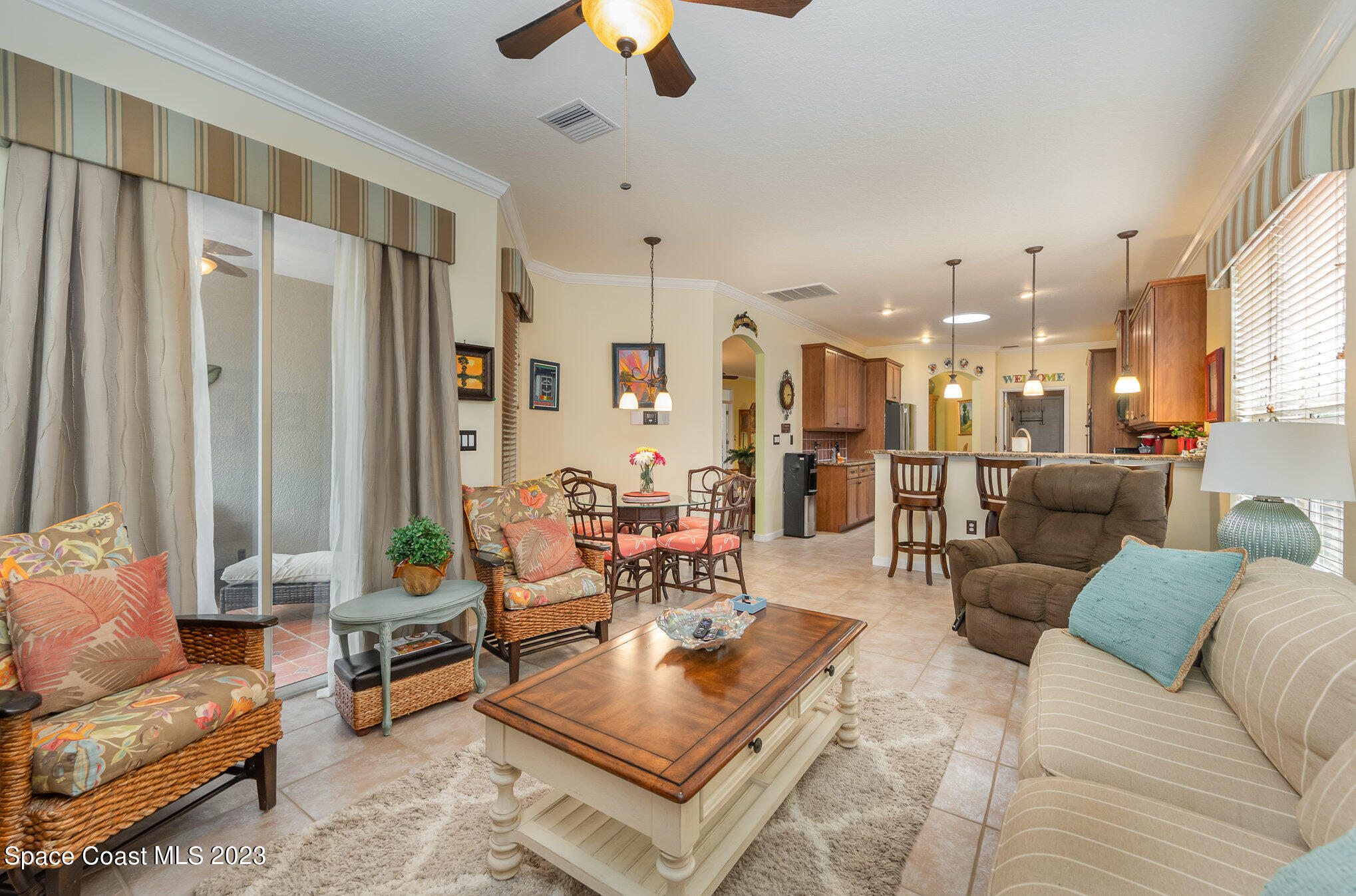 6972 Premonition Drive Melbourne, FL 32940 - Photo 16 of 33 a living room with furniture and a chandelier