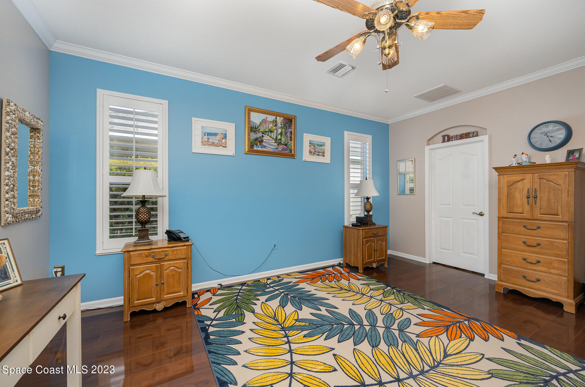 6972 Premonition Drive Melbourne, FL 32940 - Photo 18 of 33 a bedroom with a bed and wooden floor
