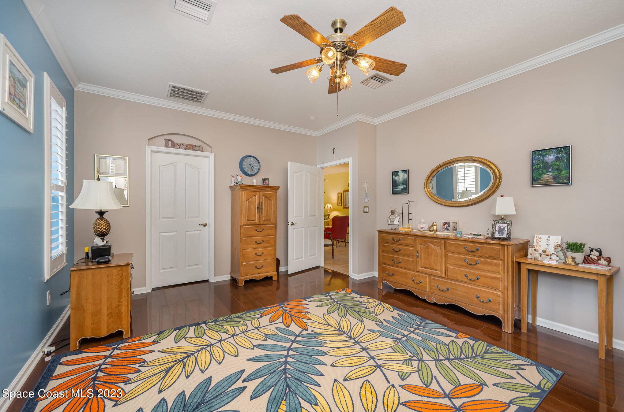 6972 Premonition Drive Melbourne, FL 32940 - Photo 19 of 33 a bedroom with a bed and a chandelier