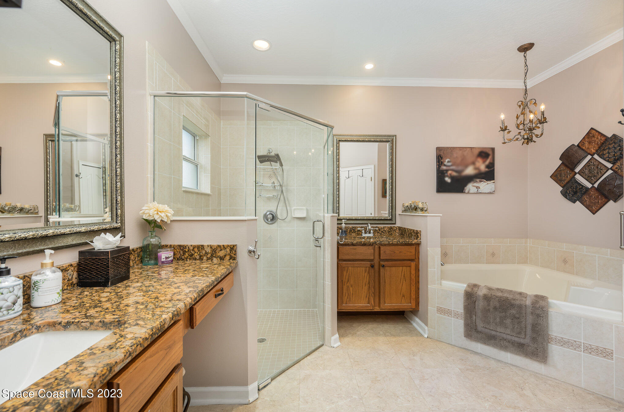 6972 Premonition Drive Melbourne, FL 32940 - Photo 20 of 33 a bathroom with a granite countertop sink a bathtub and a shower