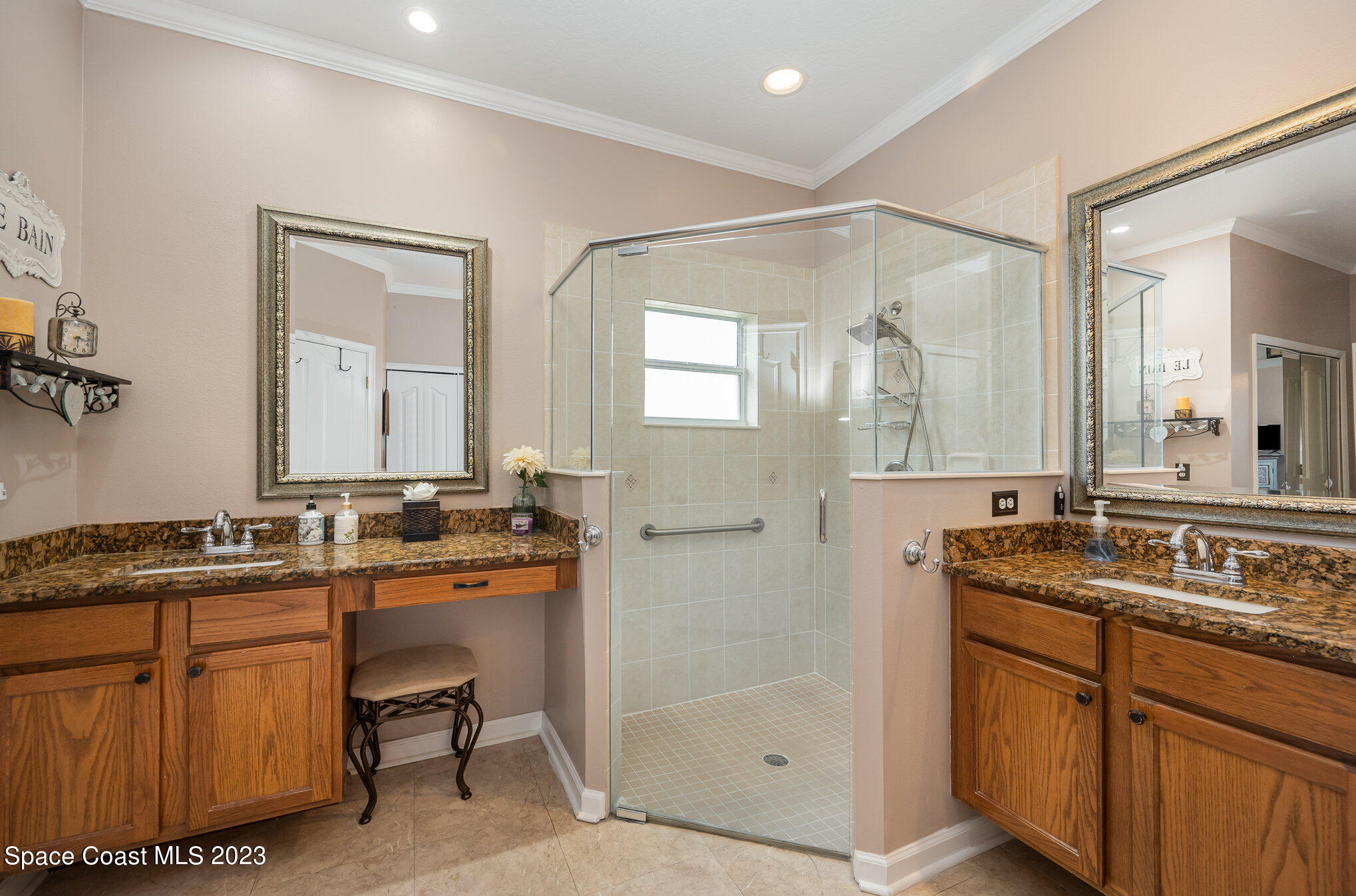 6972 Premonition Drive Melbourne, FL 32940 - Photo 21 of 33 a bathroom with a granite countertop sink a mirror a vanity and a bathtub