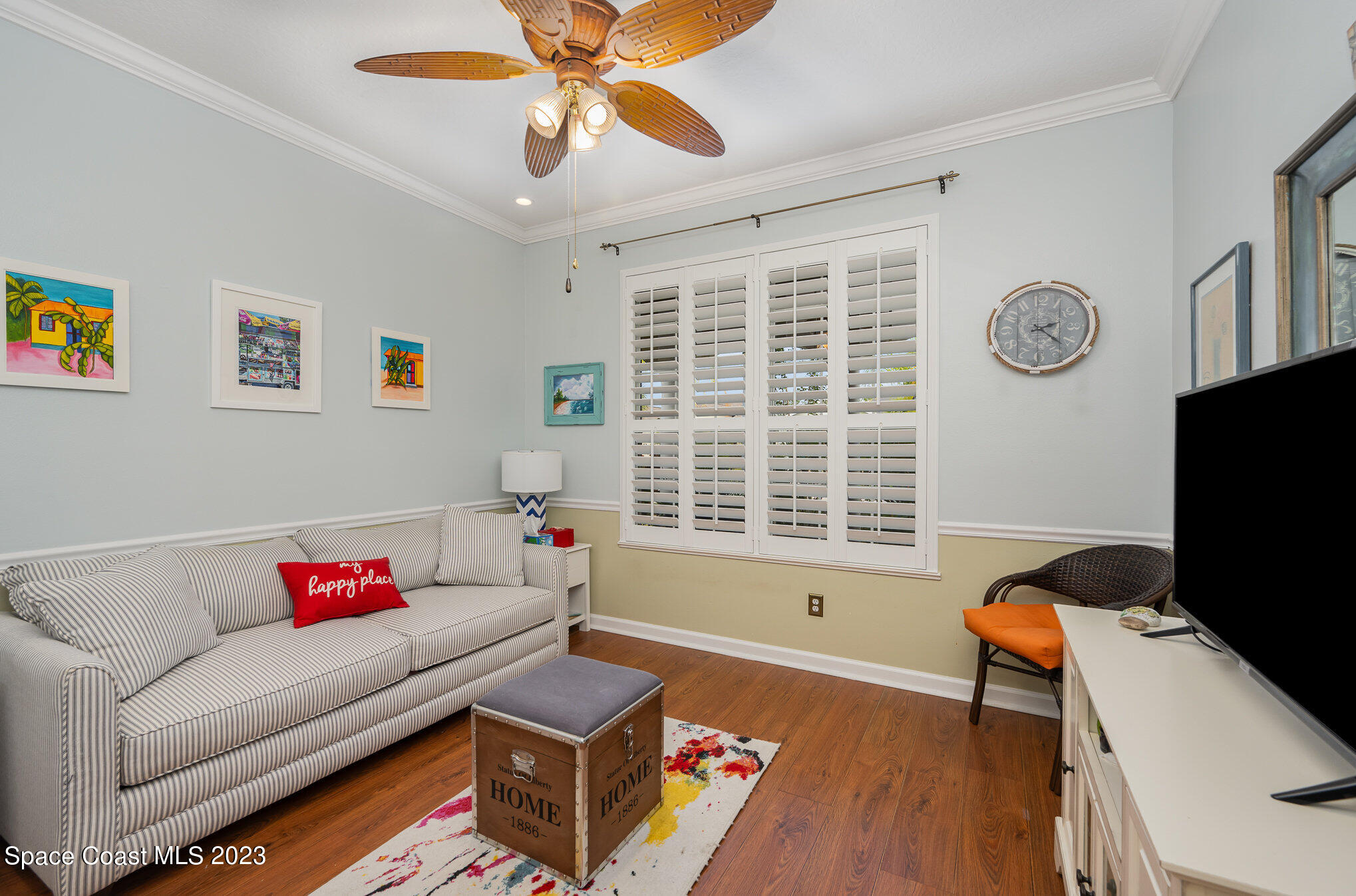 6972 Premonition Drive Melbourne, FL 32940 - Photo 25 of 33 a living room with furniture and a flat screen tv
