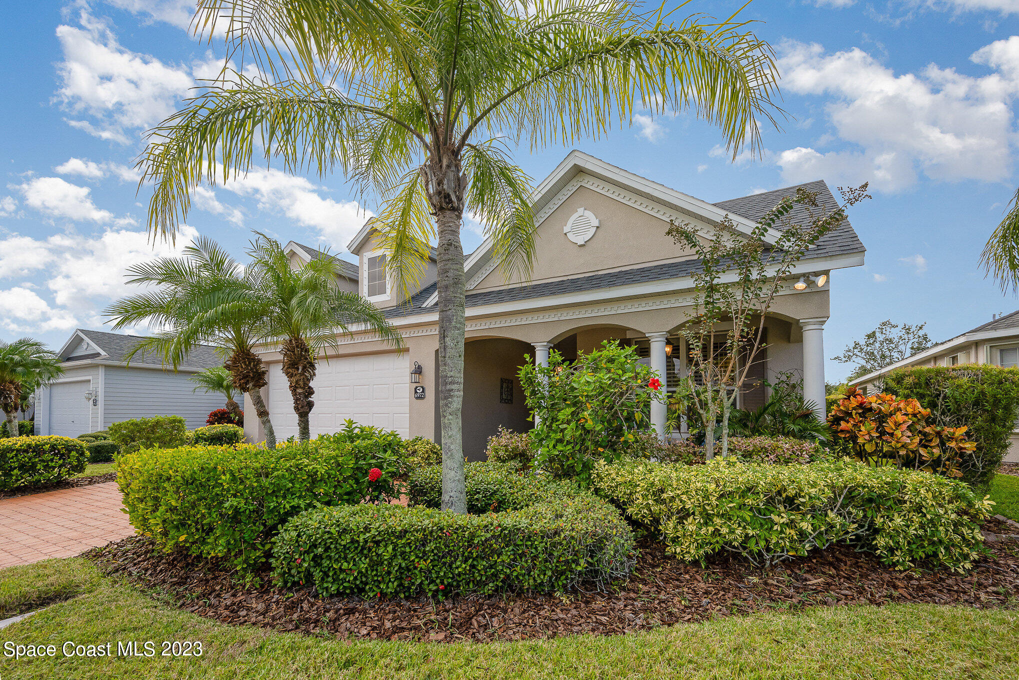 6972 Premonition Drive Melbourne, FL 32940 - Photo 3 of 33 a front view of a house with a garden