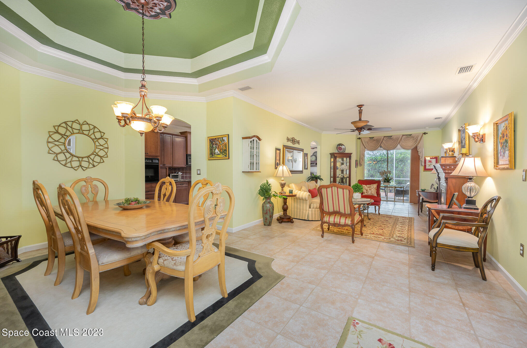 6972 Premonition Drive Melbourne, FL 32940 - Photo 7 of 33 a dining room with furniture a chandelier and window