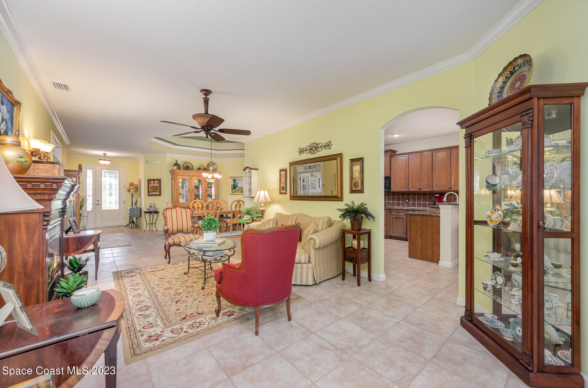 6972 Premonition Drive Melbourne, FL 32940 - Photo 8 of 33 a living room with furniture a dining table and a floor to ceiling window