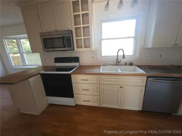 a kitchen with a sink stove and microwave