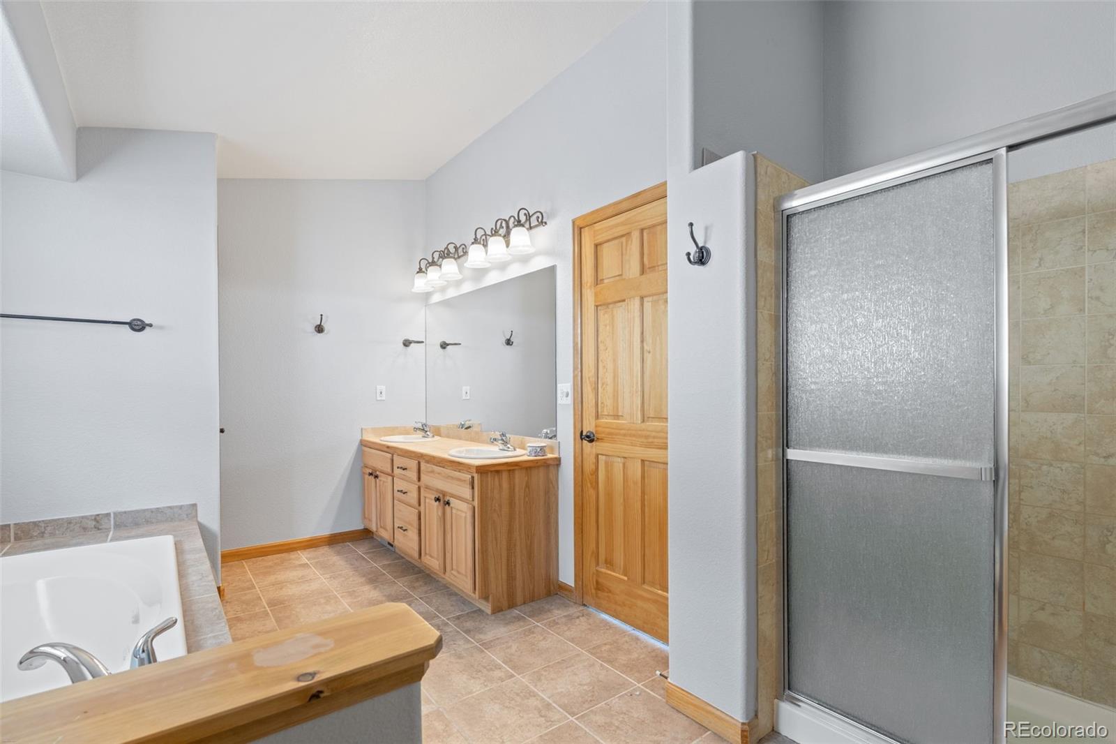 377 Deer Trail Drive Bailey, CO 80421 - Photo 17 of 44 a bathroom with a granite countertop sink and a mirror