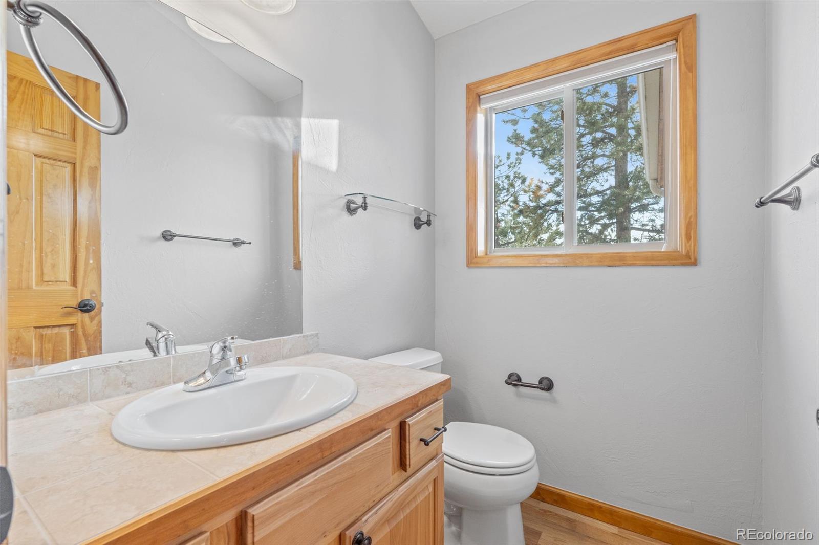 377 Deer Trail Drive Bailey, CO 80421 - Photo 19 of 44 a bathroom with a granite countertop sink and a mirror