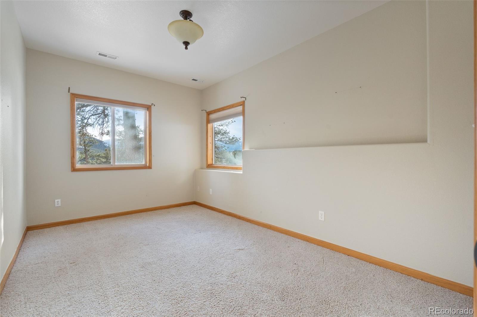 377 Deer Trail Drive Bailey, CO 80421 - Photo 23 of 44 an empty room with windows