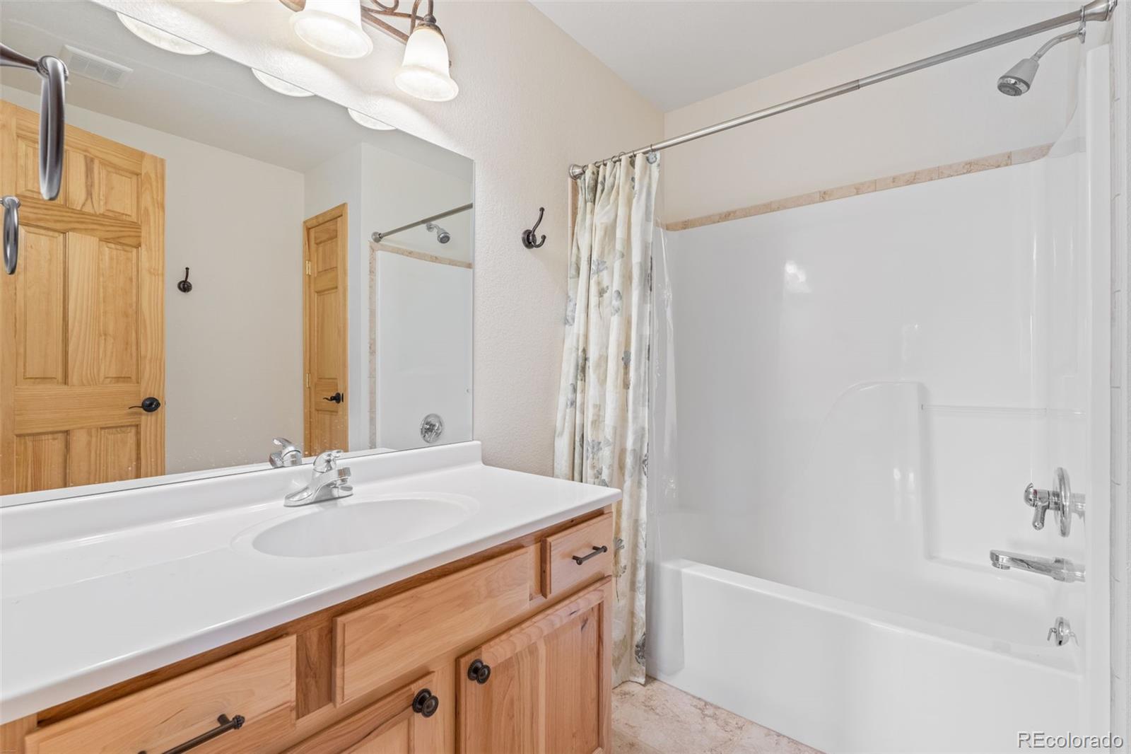 377 Deer Trail Drive Bailey, CO 80421 - Photo 24 of 44 a bathroom with a bath tub sink mirror and a shower