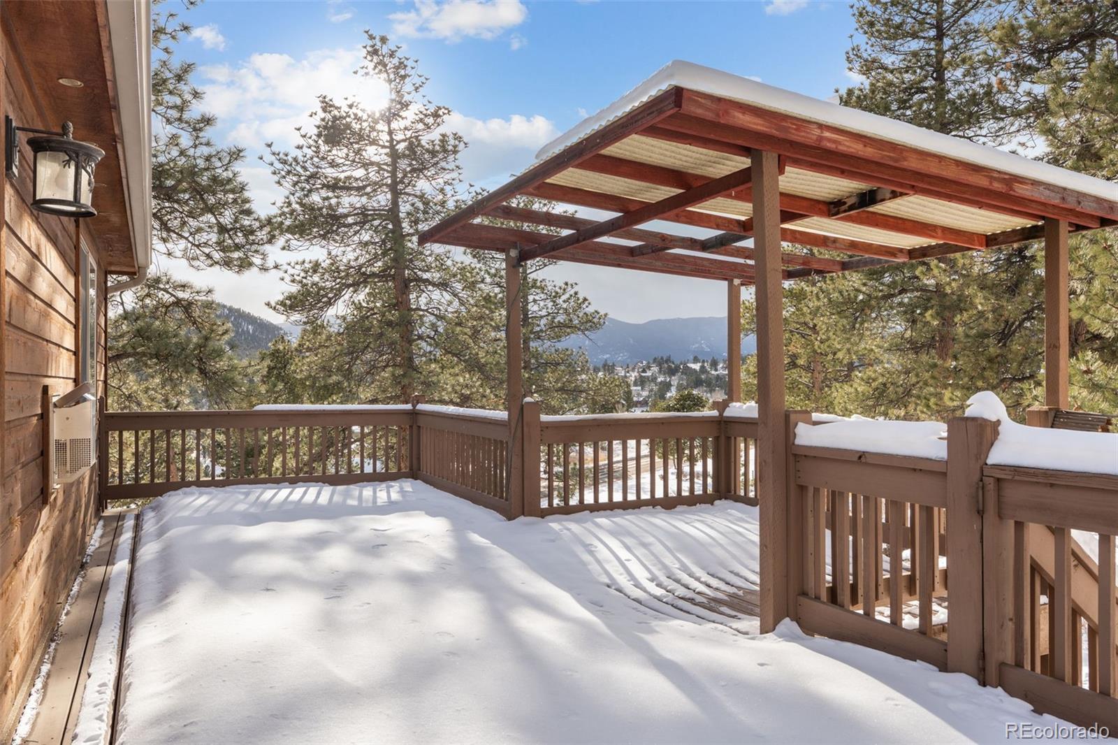 377 Deer Trail Drive Bailey, CO 80421 - Photo 28 of 44 a view of a wooden deck with a backyard