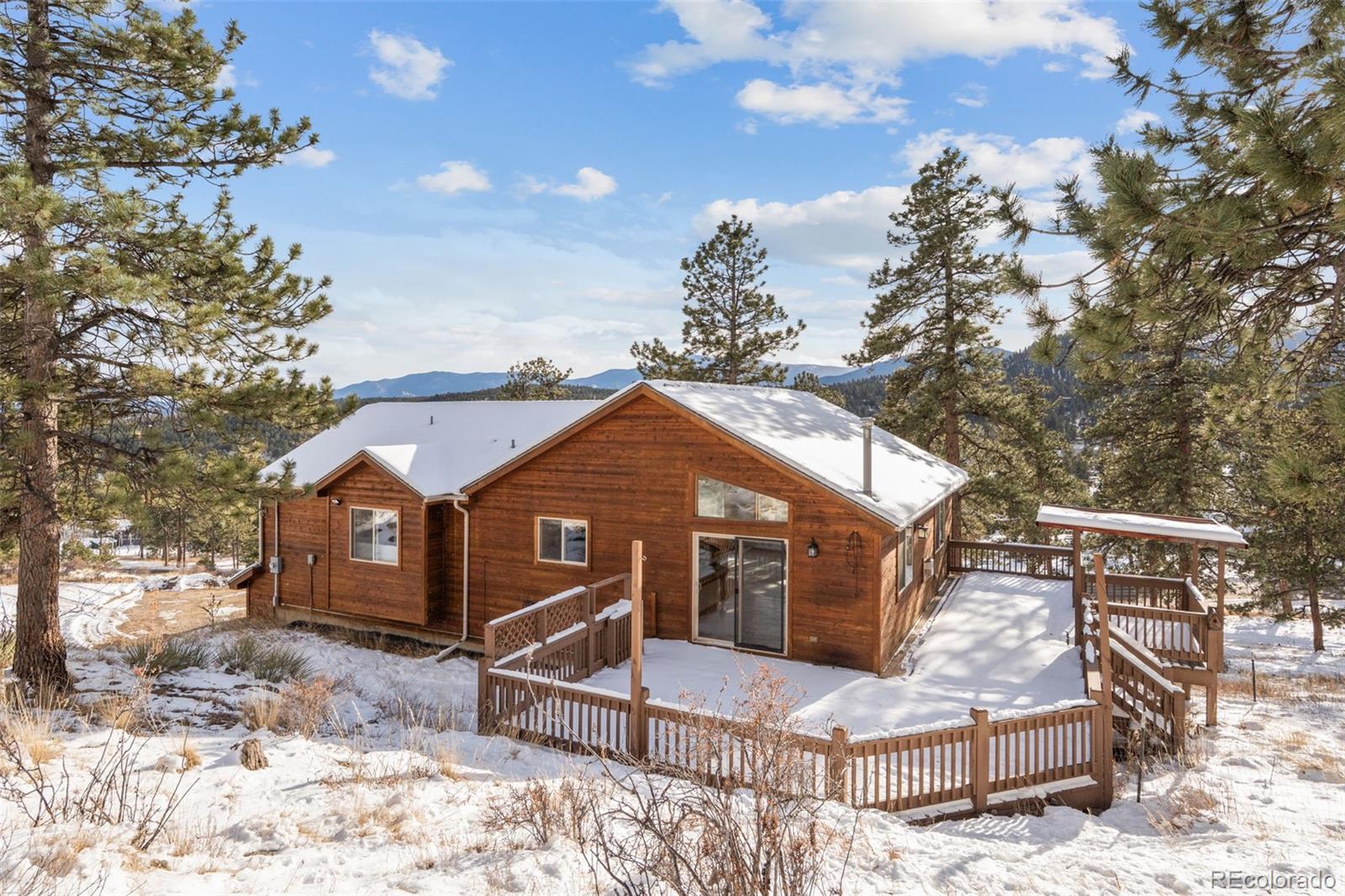 377 Deer Trail Drive Bailey, CO 80421 - Photo 31 of 44 a front view of a house with a yard