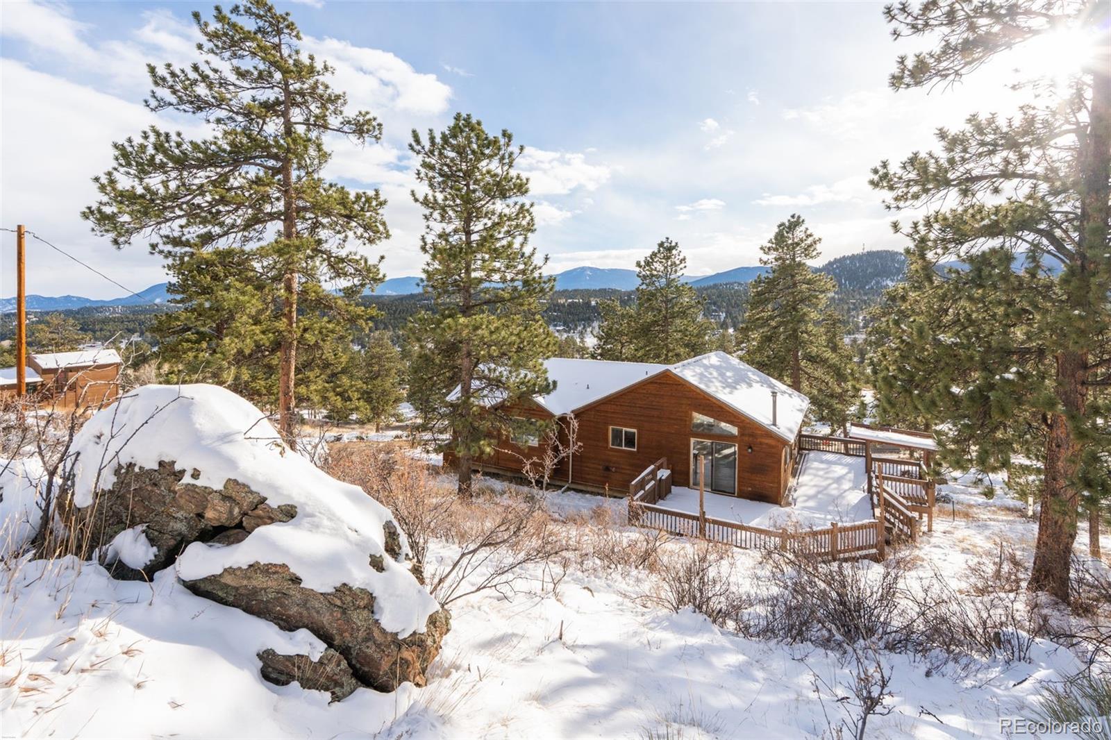 377 Deer Trail Drive Bailey, CO 80421 - Photo 32 of 44 a view of a house with a yard covered in snow
