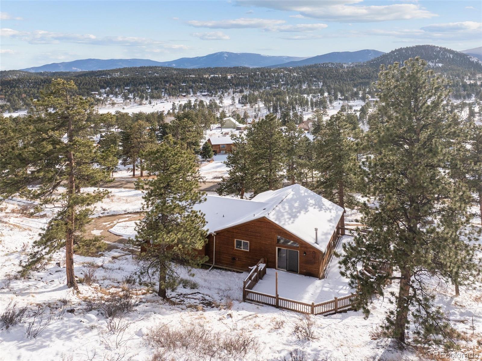 377 Deer Trail Drive Bailey, CO 80421 - Photo 38 of 44 an aerial view of a house with a yard and mountain view in back