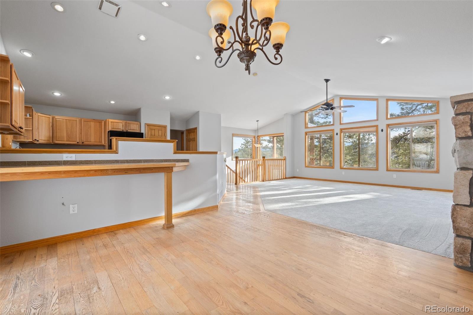 377 Deer Trail Drive Bailey, CO 80421 - Photo 10 of 44 a view of a kitchen with stainless steel appliances granite countertop a stove top oven a sink dishwasher and white cabinets with wooden floor