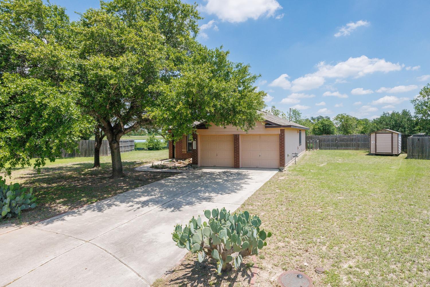 359 Spring Branch Loop Kyle, TX 78640 - Photo 16 of 17 a front view of a house with a yard and a garage