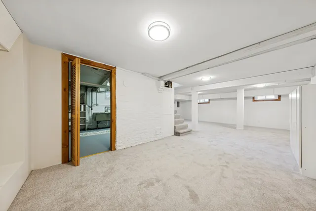 an empty room with closet and windows