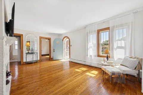a view of a livingroom with furniture and a flat screen tv