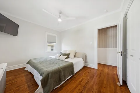a bedroom with a bed and wooden floor