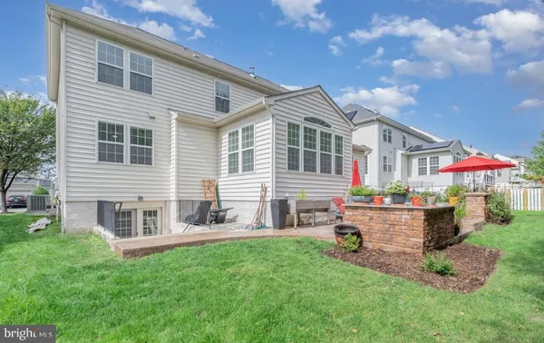 a front view of house with yard and outdoor seating