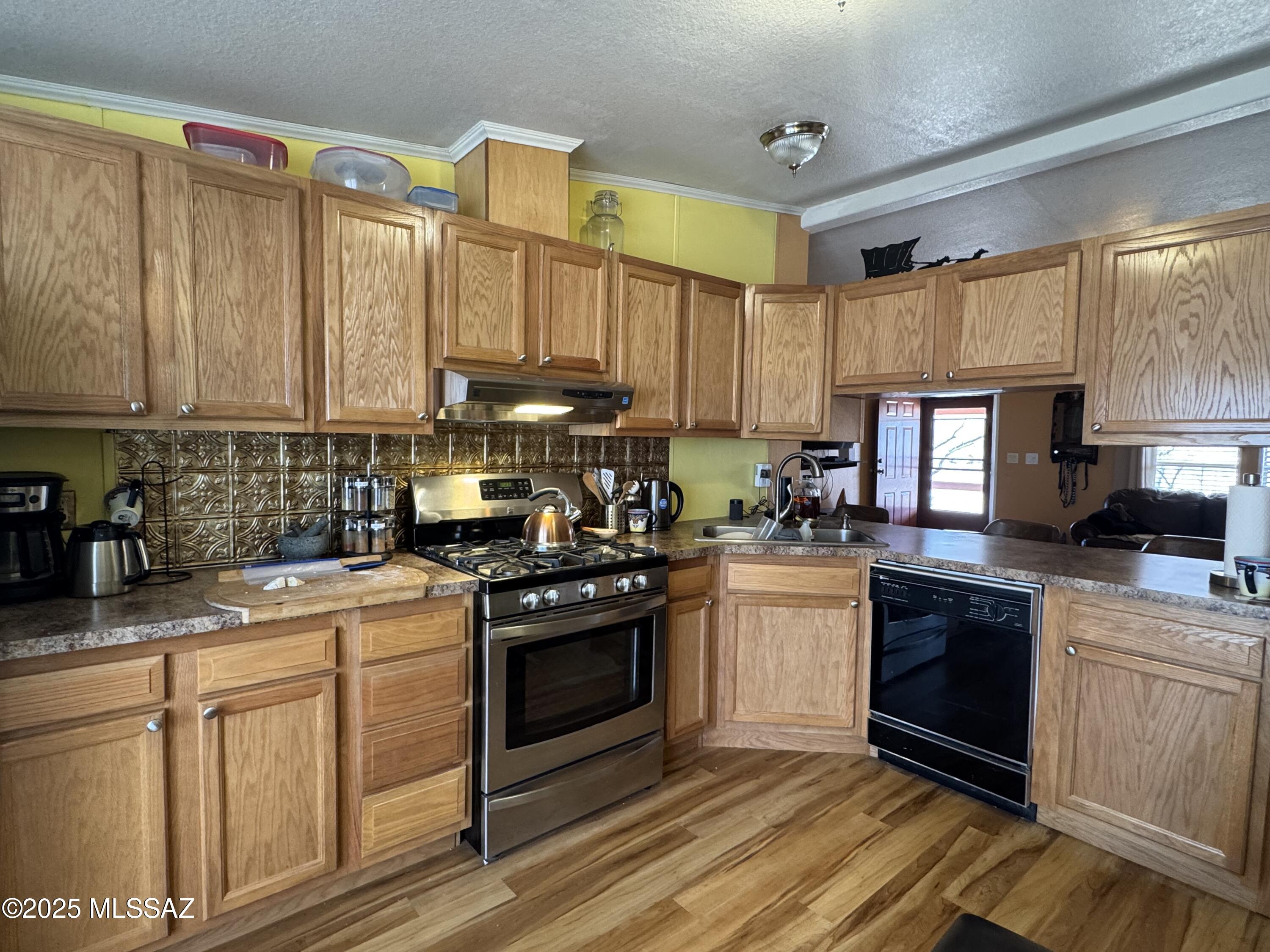 12440 South Coleman Road Tucson, AZ 85735 - Photo 20 of 45 a kitchen with stainless steel appliances granite countertop a stove a sink and a refrigerator