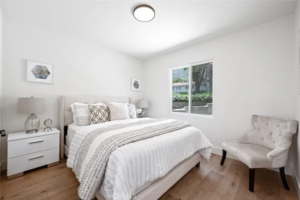 a bedroom with a bed and a chair
