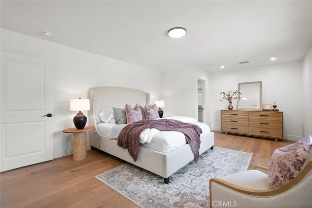 a bedroom with a bed and glass door