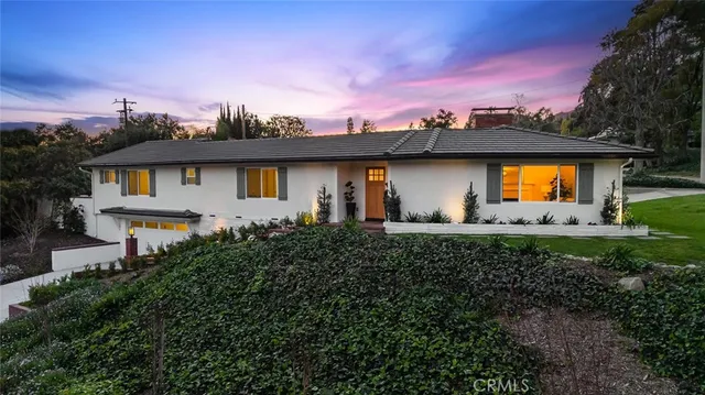 a front view of a house with a garden and a yard