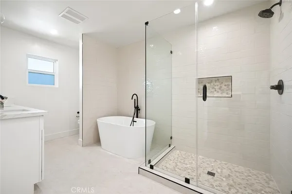a bathroom with a shower a mirror and a sink