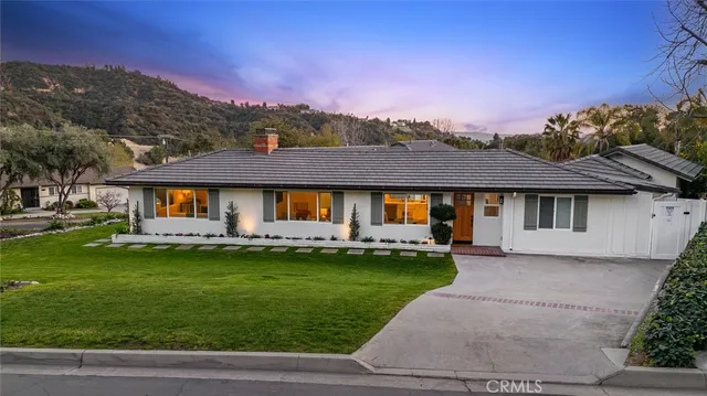a front view of a house with a garden