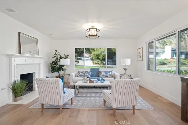 a living room with furniture fireplace and window