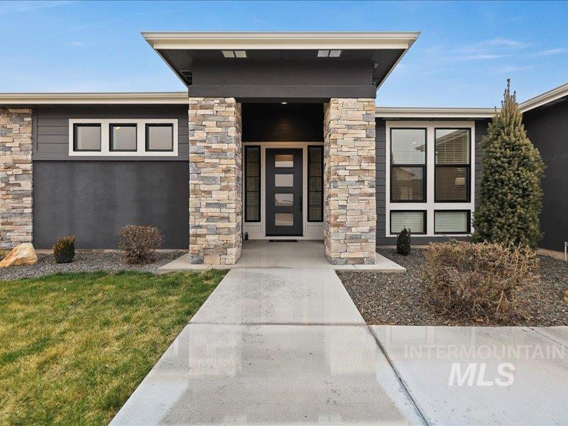 3882 West Haverhill Street Eagle, ID 83616 - Photo 2 of 38 Property entrance featuring stone siding and a yard