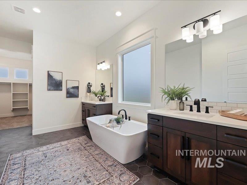 3882 West Haverhill Street Eagle, ID 83616 - Photo 25 of 38 Full bathroom featuring a soaking tub, two vanities, a walk in closet, and recessed lighting