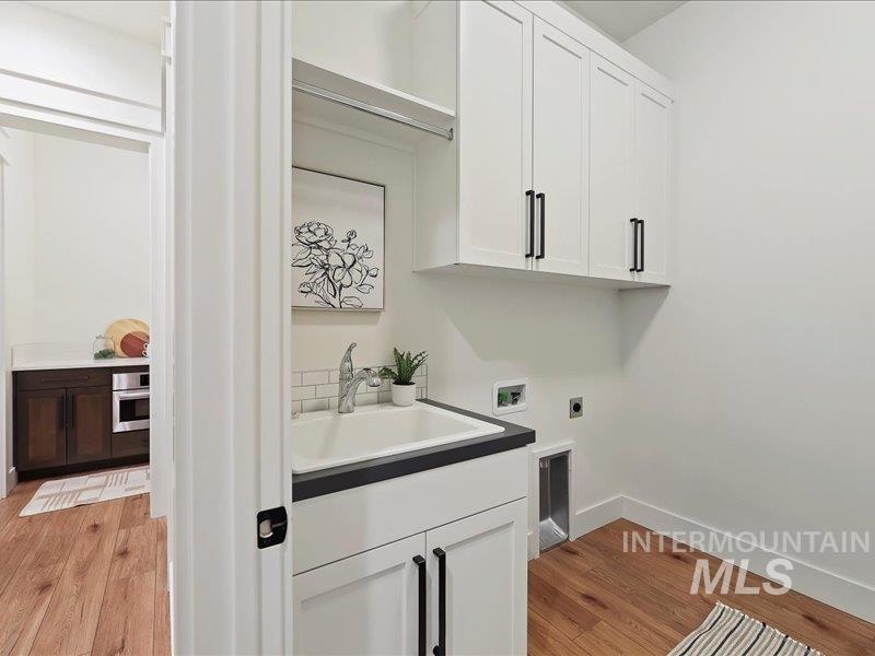 3882 West Haverhill Street Eagle, ID 83616 - Photo 35 of 38 Laundry area featuring light wood finished floors, cabinet space, hookup for a washing machine, and electric dryer hookup