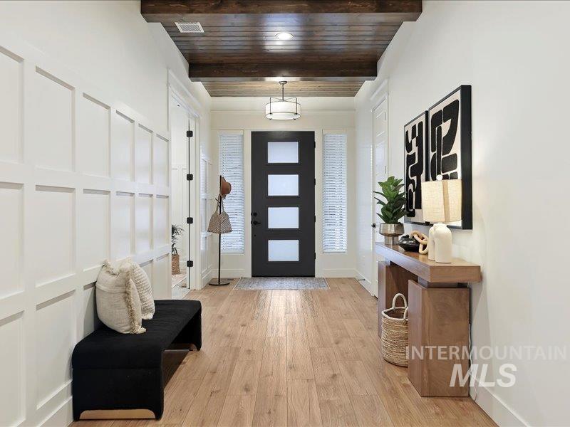 3882 West Haverhill Street Eagle, ID 83616 - Photo 5 of 38 Entrance foyer with light wood finished floors and a wooden ceiling with exposed beams