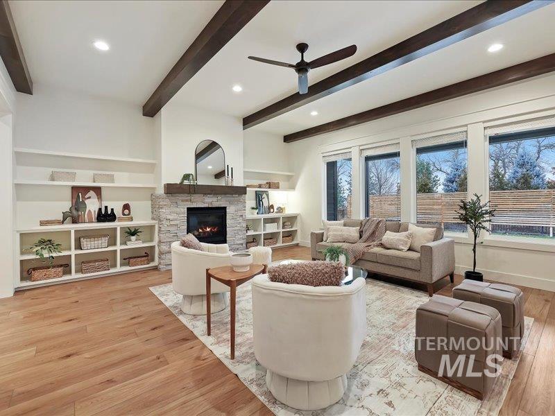 3882 West Haverhill Street Eagle, ID 83616 - Photo 9 of 38 Living room featuring recessed lighting, built in shelves, light wood-style floors, a fireplace, and ceiling fan
