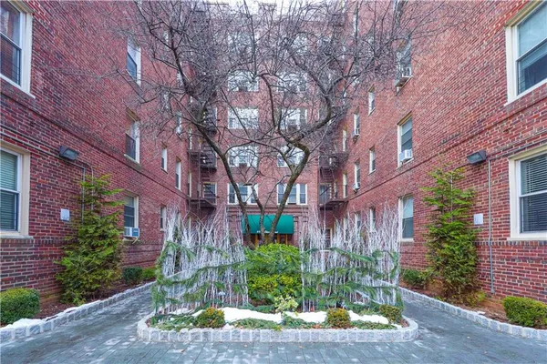 a front view of a building with garden