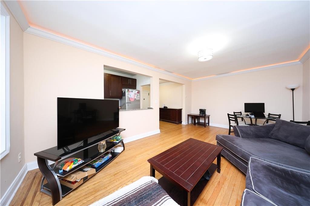 9281 Shore Road, Unit 220 Brooklyn, NY 11209 - Photo 11 of 17 a living room with furniture and a flat screen tv